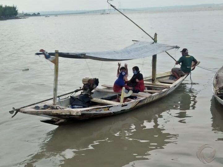 Wisatawan naik perahu nelayan di tempat wisata Kenjeran Baru Surabaya saat libur tahun baru 2021, Sabtu (2/1/2021).