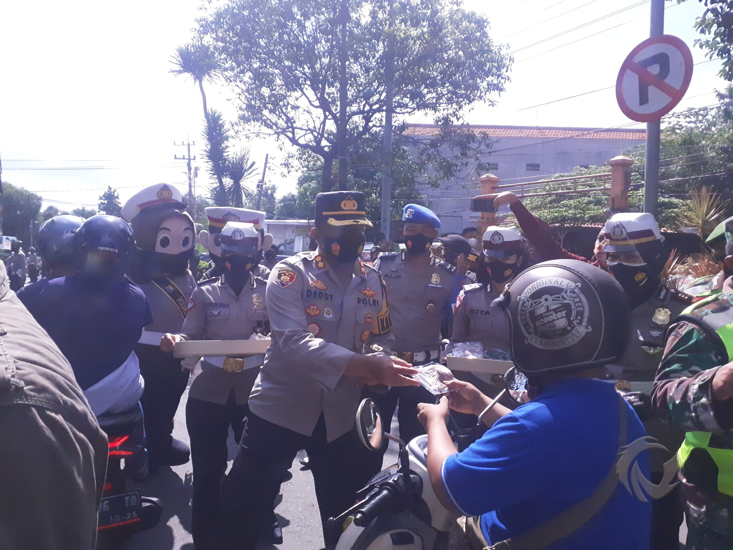 Kapolresta Mojokerto, AKBP Deddy Supriadi membagikan masker pada pengguna jalan di simpang empat Empunala, Kota Mojokerto, Senin (02/01/2020).
